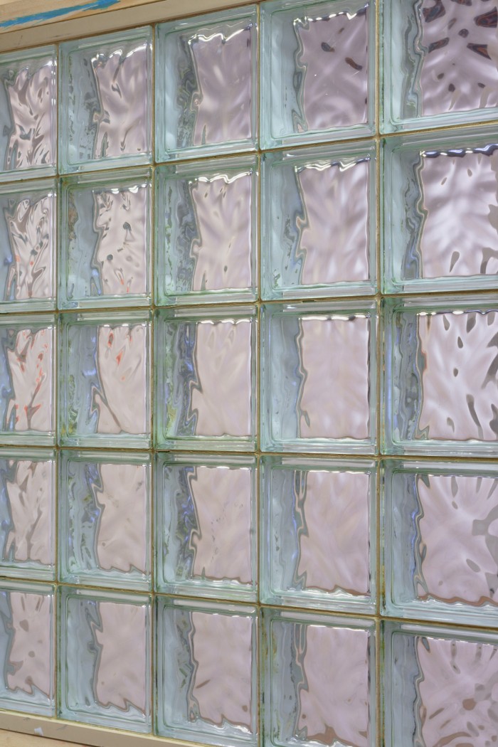 A close up photo of a window made of glass bricks