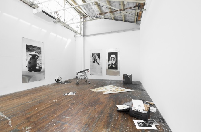 Aluminium screen prints amongst an installation of past work.