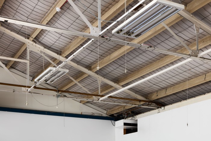 Approximately six star sculptures of various size suspended from lightweight chain.