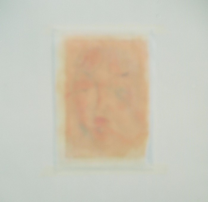 One of the coloured portrait drawings is out of focus in the centre of a white square.