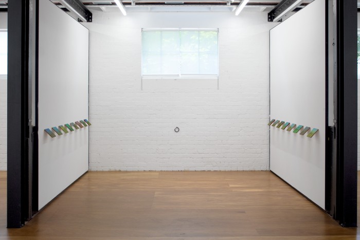 Install veiw of a down stairs space in the Stables at VCA. On the white walls hang small green paintings of imaginary parks all hung on a 45 degree angle and 1 metre above the ground.
