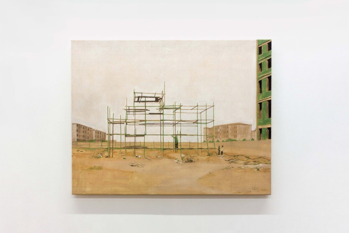 Landscape oil painting on canvas. Empty scaffolding on sand with three small people standing next to it. Slight profile of a green building on right.