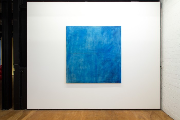Big blue almost square painting with white and grey green rectangular grid drawn on top.
